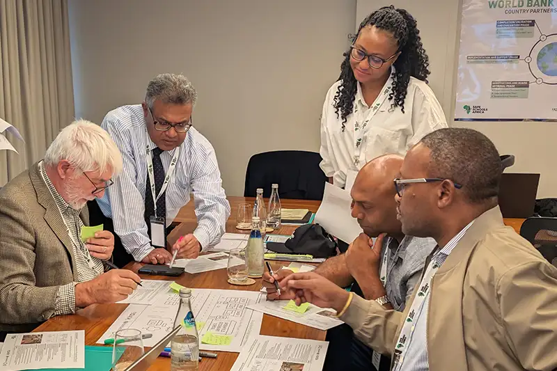 Participants engaged in group work to evaluate risks and address safety needs in rural and urban environments.